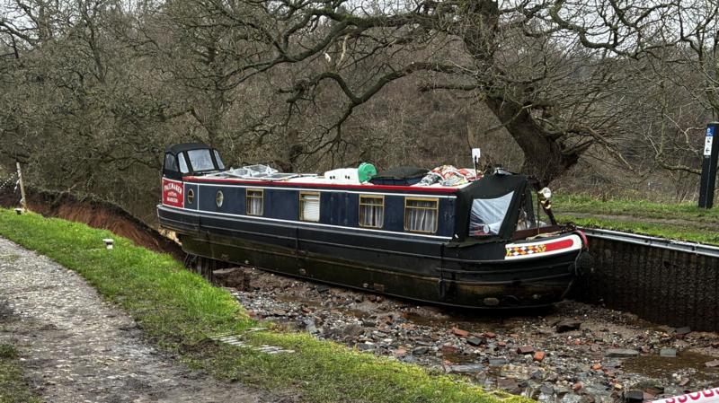 Boat stranded on canal hole edge pulled to safety