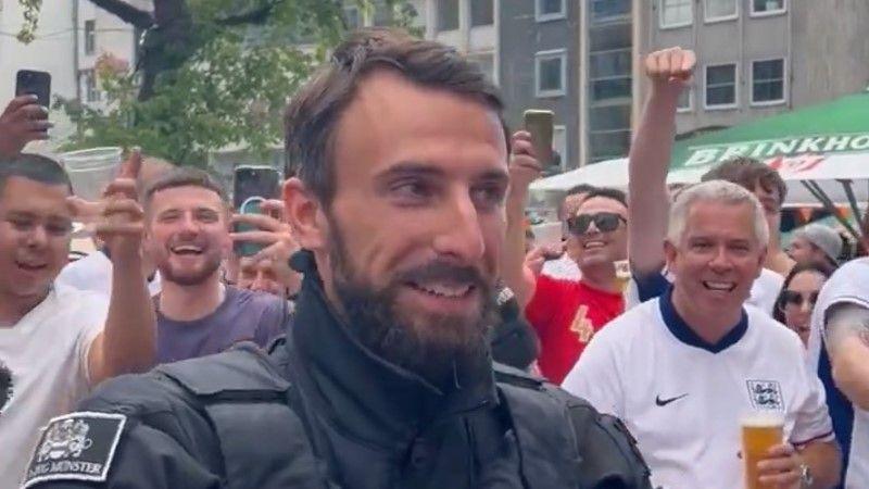 A Dortmund cop who looks like Gareth Southgate is serenaded by England fans