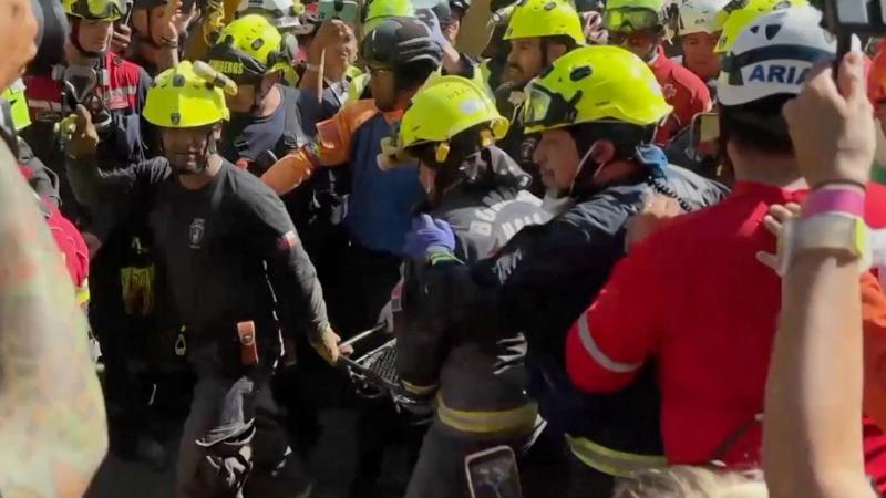 Cheers and applause as security guard rescued from rubble