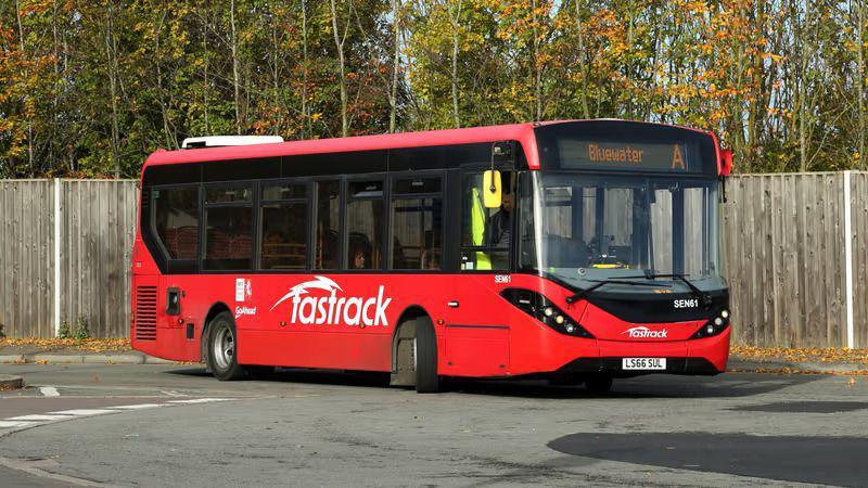 A red bus with "fastrack" on the side.