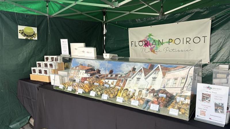 A Florian Poirot stall, with macarons in a glass case.