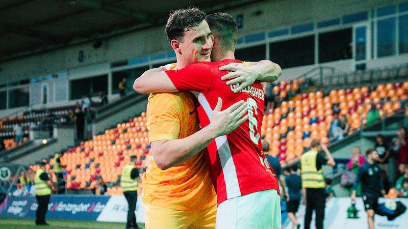 Rohan Ferguson hugs Chris Gallagher