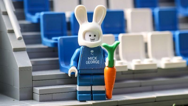 A Lego version of Posh club mascot Peter Burrow, who is holding a carrot