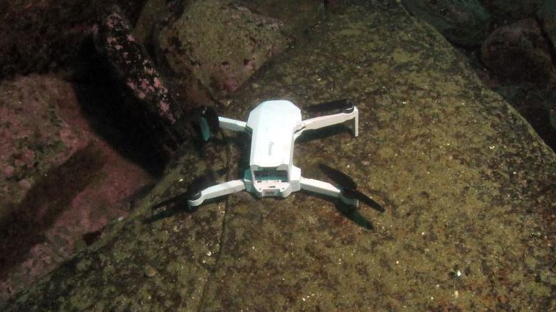 The drone on a rock underwater