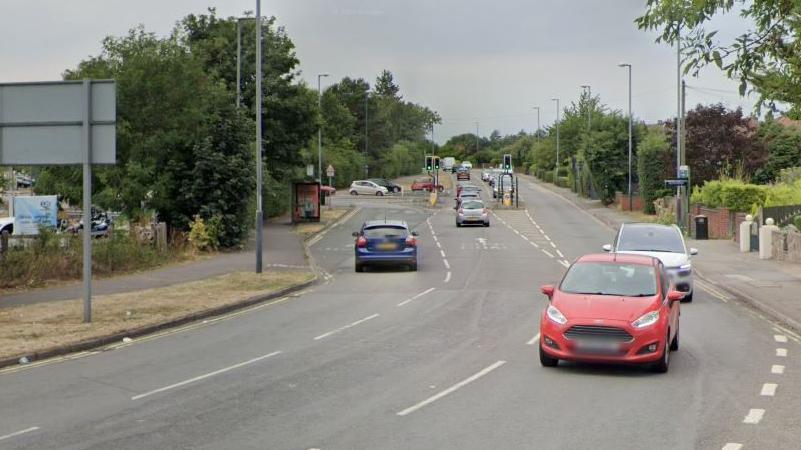 A general view of Derby Road. It is a two lane road with access to the Asda supermarket on the right.