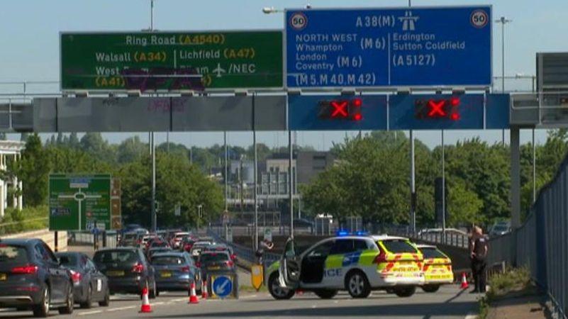 The scene of the crash with police blocking off the road