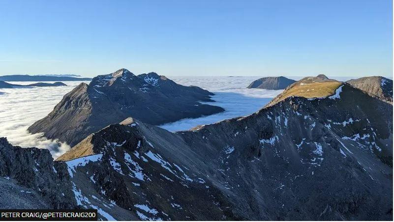 A photo valley cloud with sunny skies over mountains