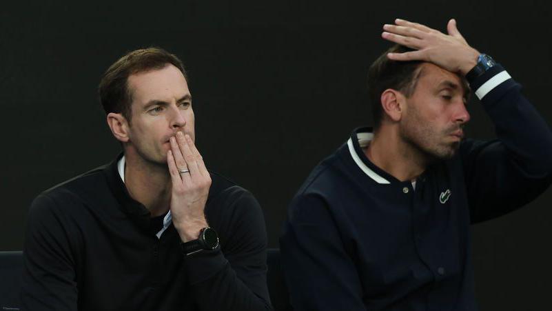 Andy Murray and Carlos Herrera Gomez react at the Australian Open