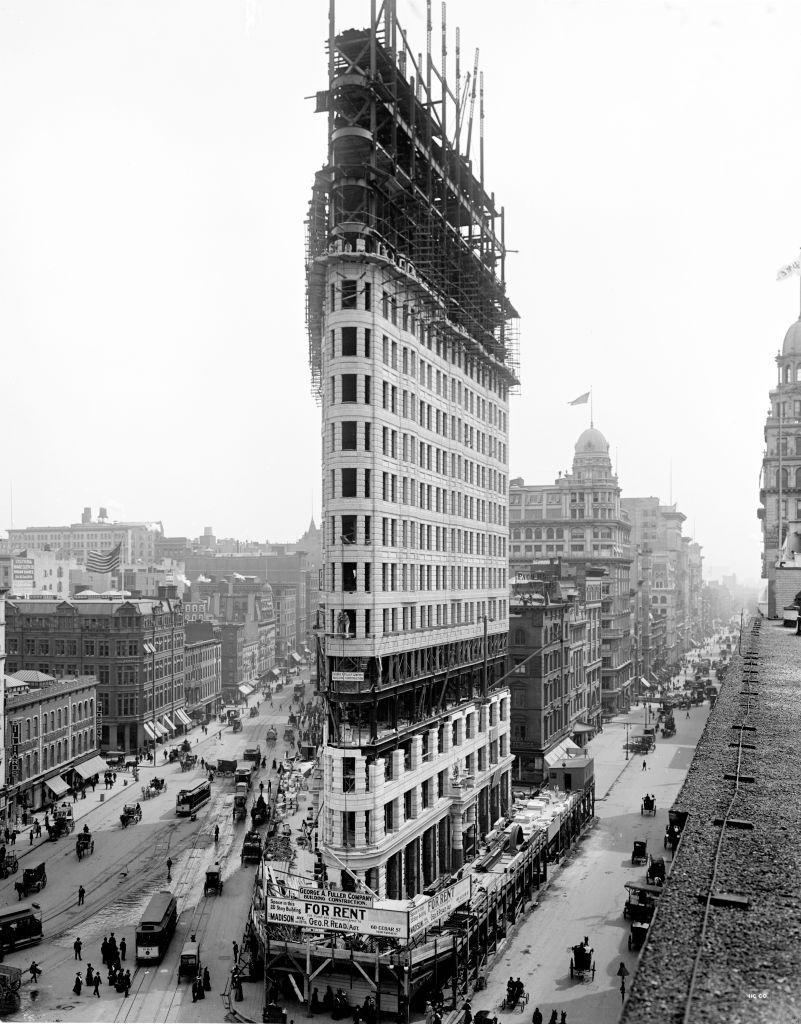 historic black and white photo of the Flatiron Building being constructed