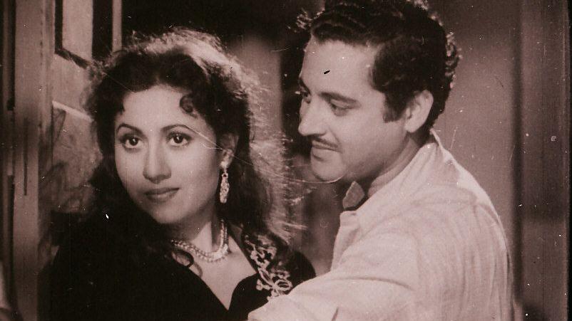 A black and white still of Guru Dutt and his co-star Madhubala from the film Mr & Mrs 55