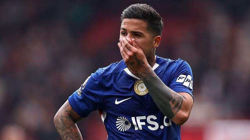 Enzo Fernandez looking disappointed with his hand on his face during a Chelsea game