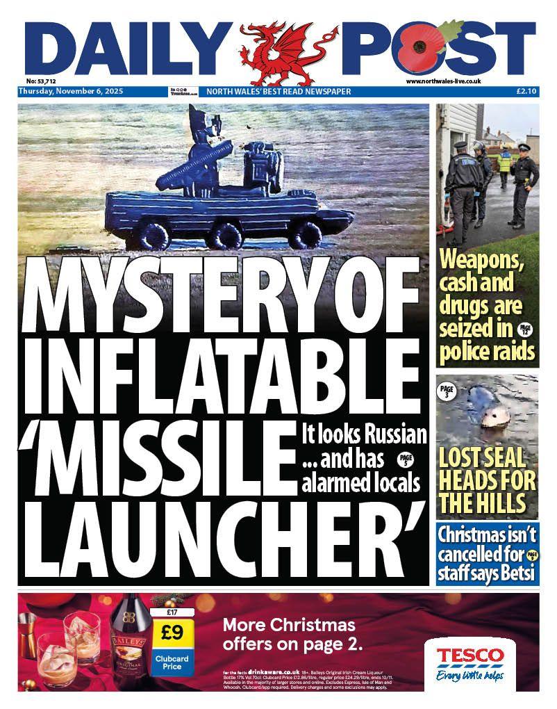Front page of the Daily Post shows main headline: "Mystery of inflatable 'missile launcher'", beneath an image of an inflatable military looking black vehicle parked in a field. Other headlines read: "Weapons, cash and drugs seized in police raids", "Lost seal heads for the hills", "Christmas isn't cancelled for staff says Betsi". 