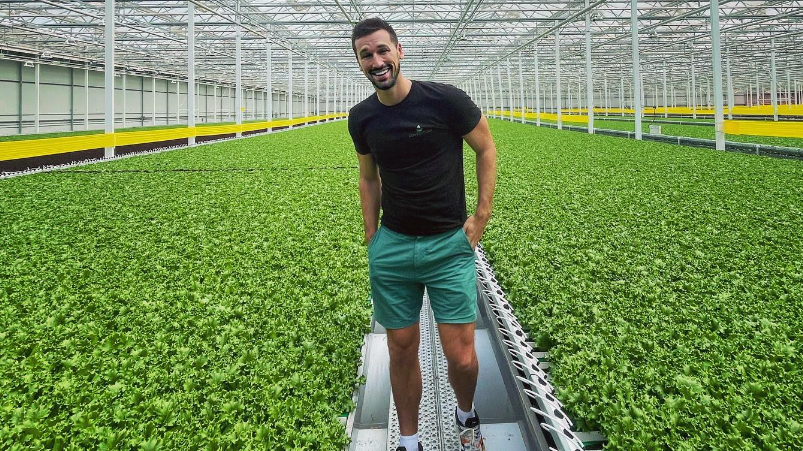 Henry Gordon-Smith in a large building full of crops