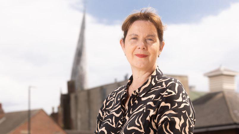 Claire Ward standing in front of the Crooked Spire in Chesterfield