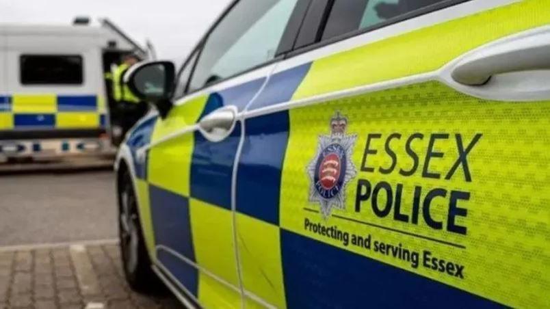 The side of an Essex Police car with the force's badge on the side