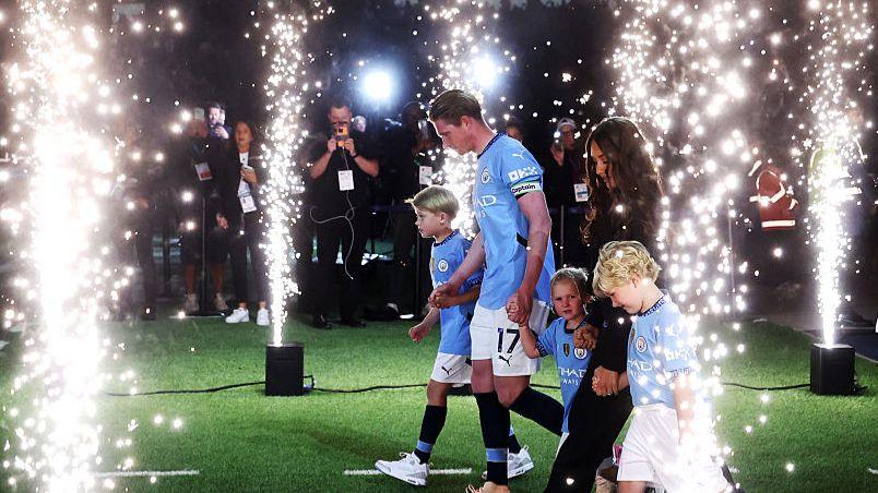 Kevin de Bruyne walks on to the pitch with his family for his Etihad Stadium farewell speech