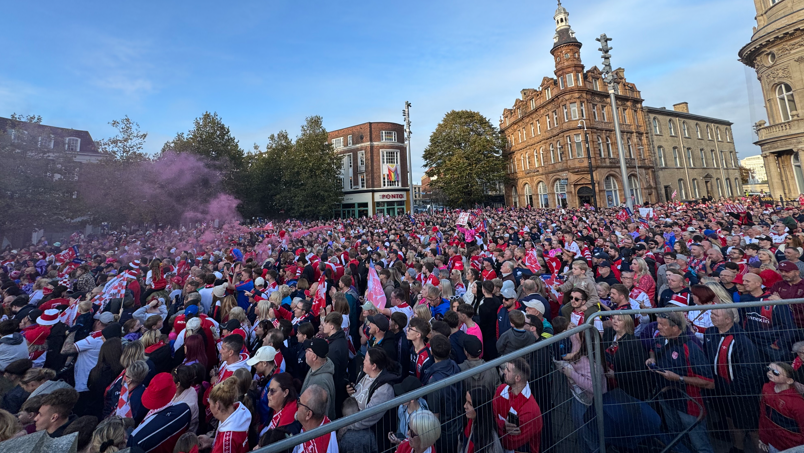 Another wider shot of the crowd in Victoria Square.  Someone at the back has let off a flare and red smoke is rising above the crowd.