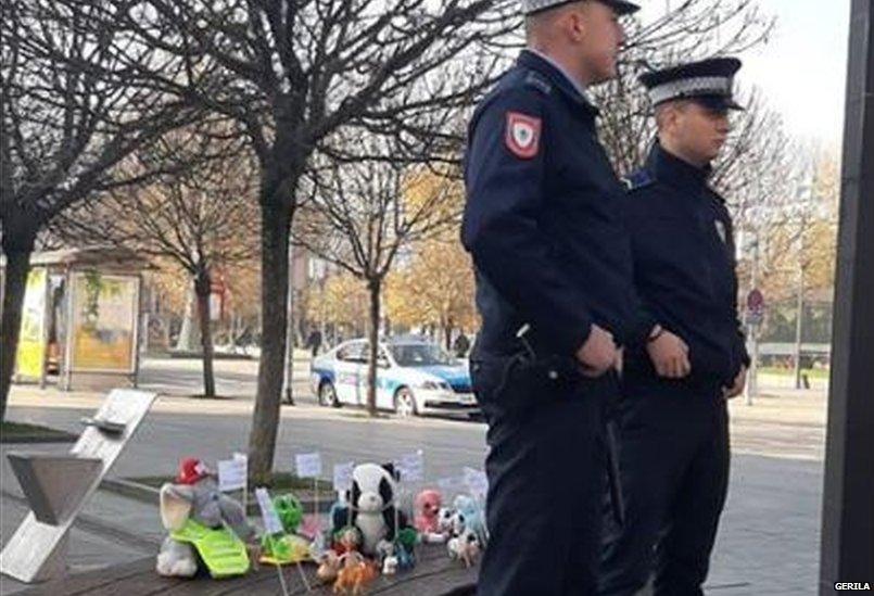 Policemen "guarding" toy protesters