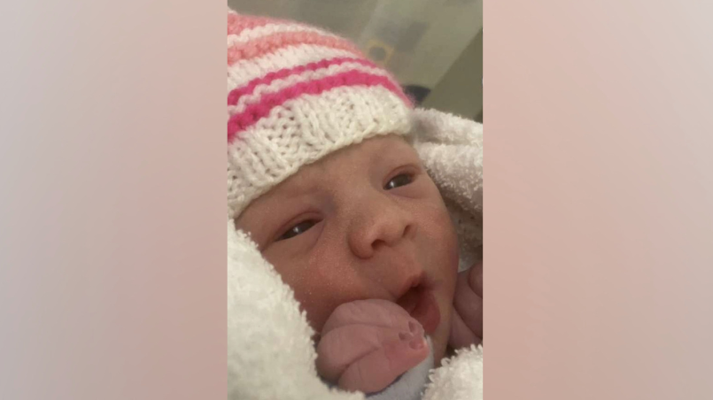 Lottie Kim James-Howard, a small baby wrapped in a blanket.