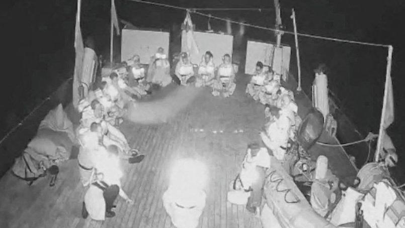 A screengrab from a live video footage shows crew members sitting in a circle aboard the Gaza-bound Alma vessel, part of the Global Sumud Flotilla