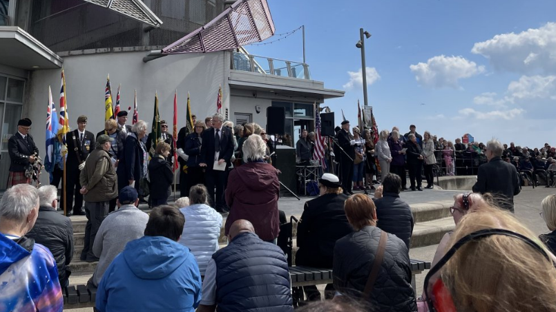 Crowds outside of Redcar's Beacon building, watching flag bearers