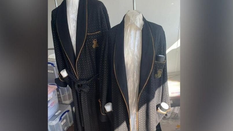 Images that Anna Tennant took of the Harry Potter school costumes, complete with black blazers with gold patterns on them