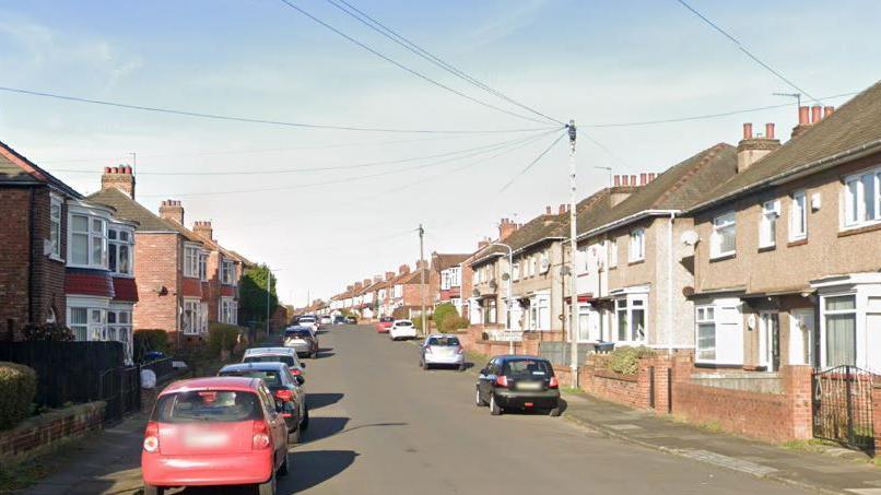 A Google Streetview screenshot of Westminster road. It is a residential street with terraced and semi-detached houses on either side and cars parked on the street.