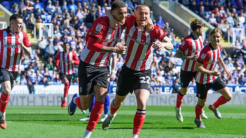 Lincoln's Ryan One celebrates his goal with team-mate Tom Hamer