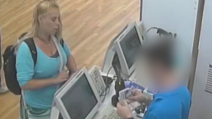 Betro is wearing a blue top with light-coloured trousers on. She has a rucksack on her back. She has blonde hair with one side partially pulled back.