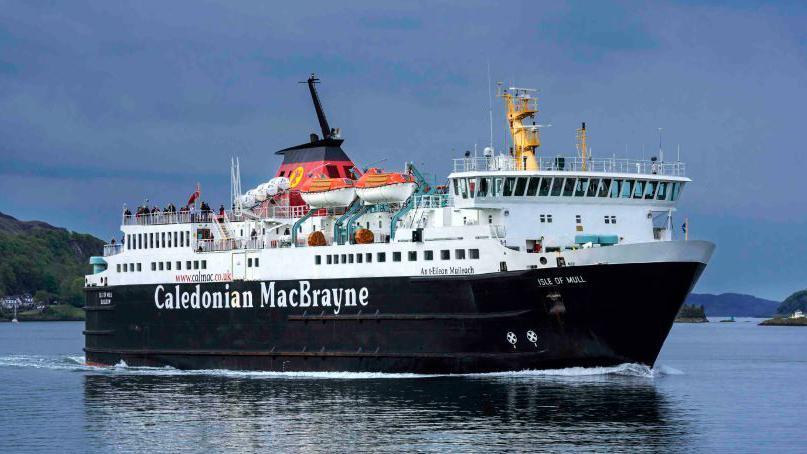 A large black and white ferry with red funnels