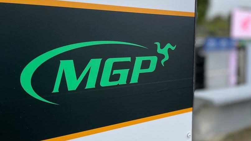 The green, black and orange MGP sign.