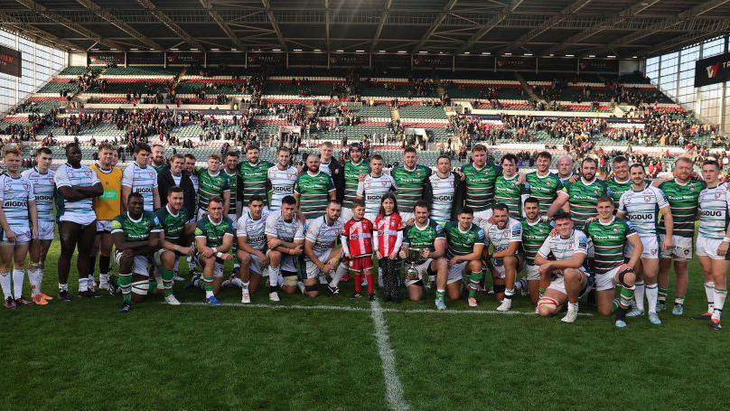 The Leicester Tigers and Gloucester teams pose with the Ed Slater Cup after Leicester's victory 