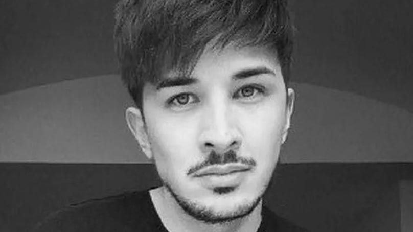 A black and white photo of Martyn Hett who has dark hair, a moustache and goatie type beard