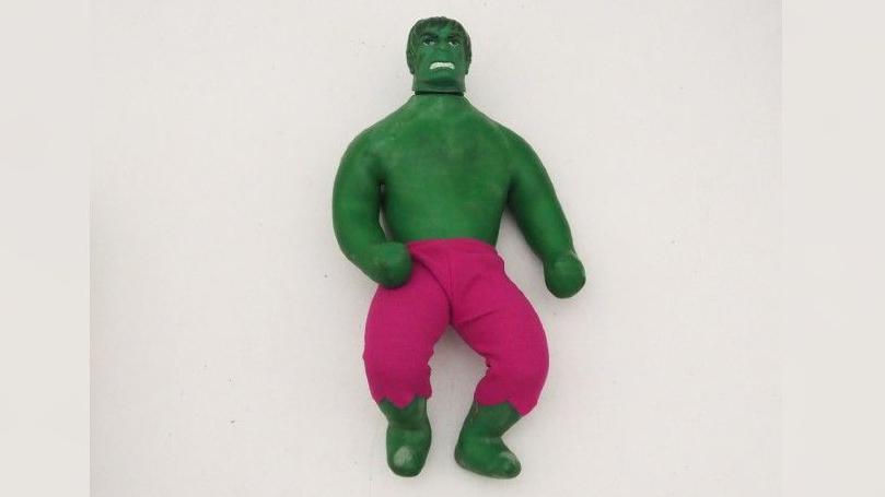 A green Hulk character is in the middle. The toy is a stretchy one, and Hulk is painted green and wearing pink trousers.