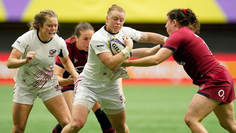 Alev Kelter is tackled by Phoebe Murray of England 