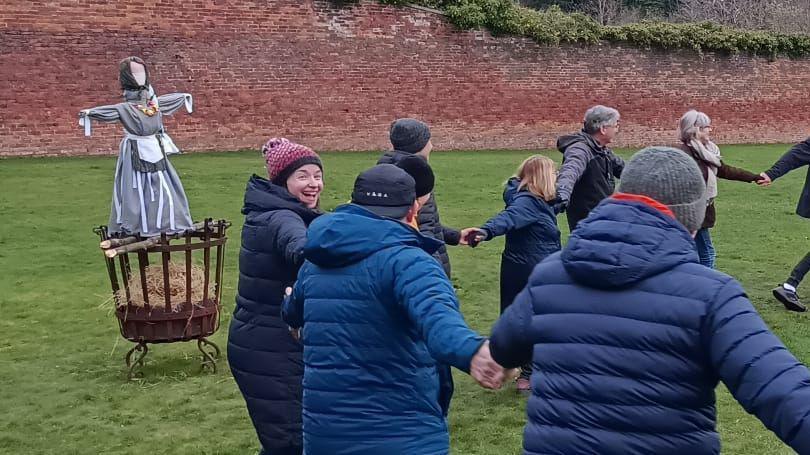 A group of people dancing in a circle 