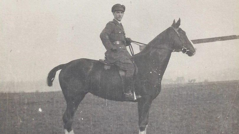 A black and white photograph of an officer on a war horse