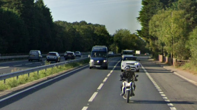 Google Maps screen grab from one side of the A12. Looking directly at traffic coming towards it with a white and blue motorbike in foreground and Range Rover and VW van in the background. 
To the left in the background, traffic can be seen going in the opposite direction. 