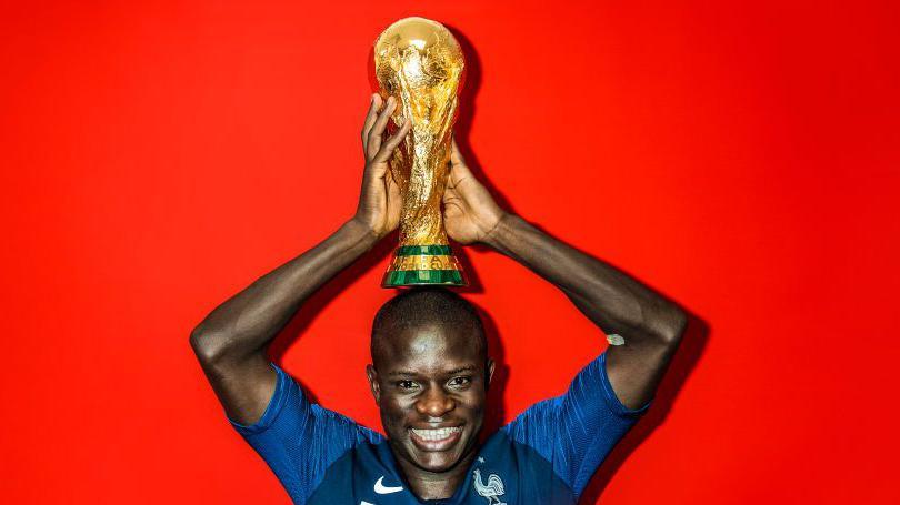 N'Golo Kante celebrates with the World Cup trophy in 2018