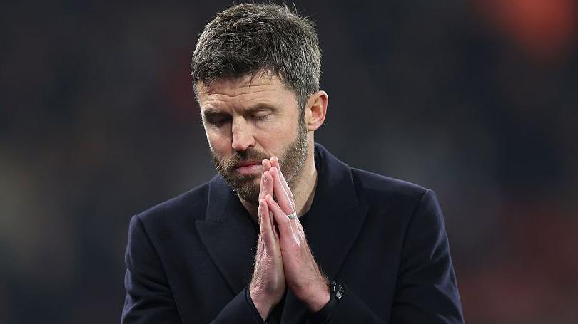 Manchester United interim boss Michael Carrick clasps his hands together