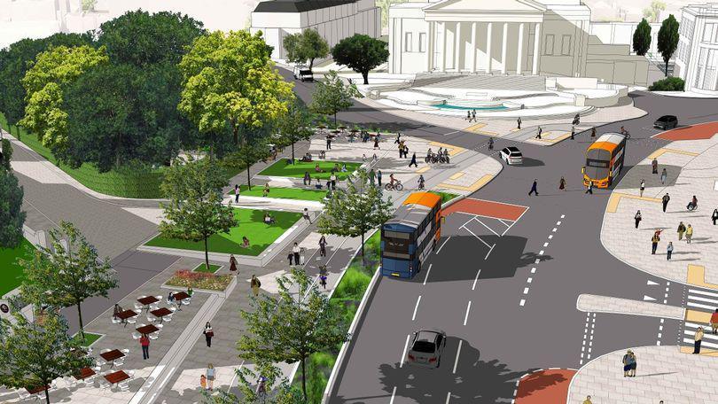 An artists impression of Queens Road, showing an existing road on the left hand side replaced with paving, green spaces and outdoor seating. There are two buses driving down the road on the right. The Victoria Rooms fountain and University of Bristol building is visible at the top.