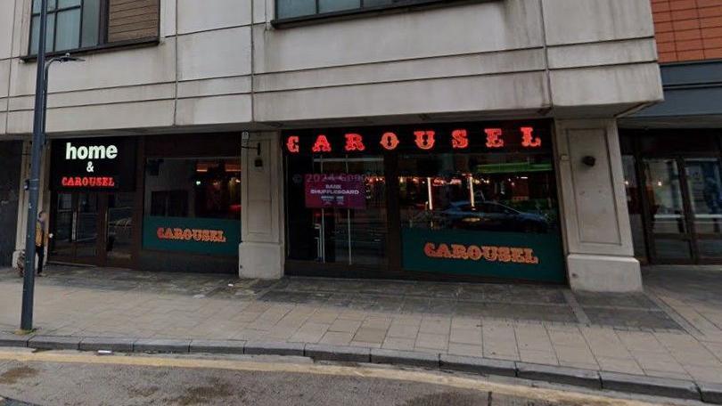 The front of Home & Carousel in Leeds. The venue is indicated by a sign above its doors. 