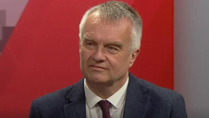 Reform UK's West Midlands regional director Pete Durnell, looks to the left, in the BBC Politics Midlands studio - he is wearing a white shirt, dark tie and suit