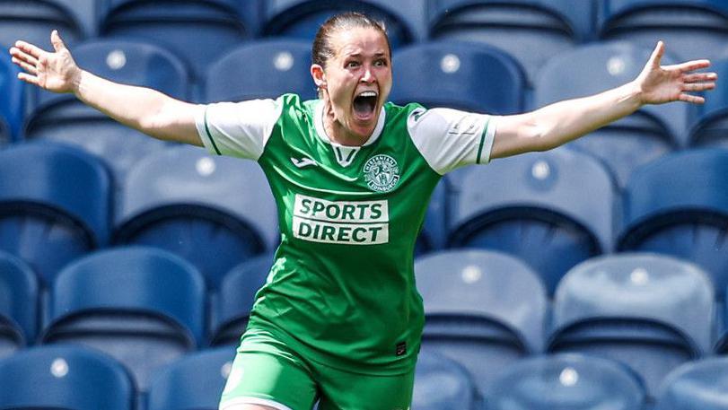 Linzi Taylor celebrates her goal with arms outstretched