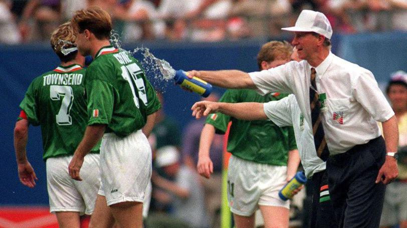 Republic of Ireland manager Jack Charlton splashes water on Tommy Coyne during the Fifa World Cup 1994 match against Italy