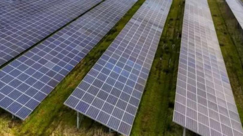 Solar panels in a green field