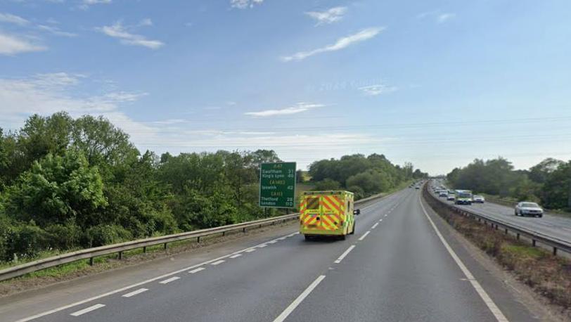 A stretch of dual carriageway with a green road sign specifying the number of miles to a list of destinations including Ipswich.