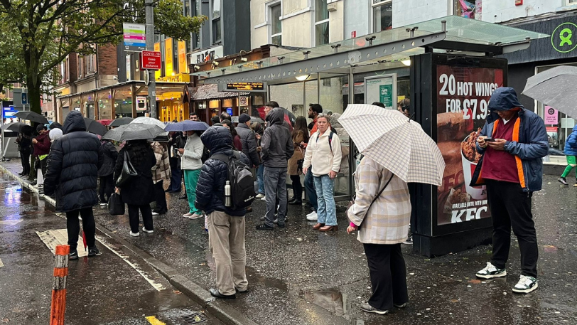 Commuters waiting on bus in rain Dublin Road 