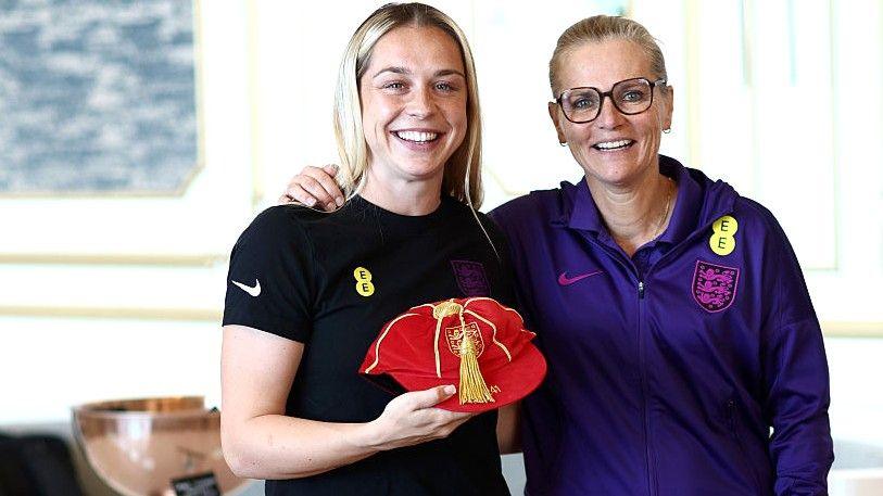 Poppy Pattinson holds her England cap alongside Sarina Wiegman