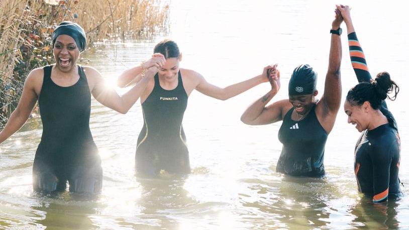 Four women in a lake. Left to right: Roni Bruno, Lexi Sandiford, Jasmine Boatswain and Alice Dearing.